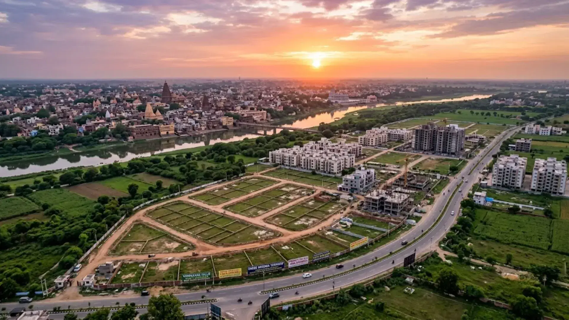 Aerial view of a plotted development in Vrindavan with residential plots, roads, greenery and surrounding development