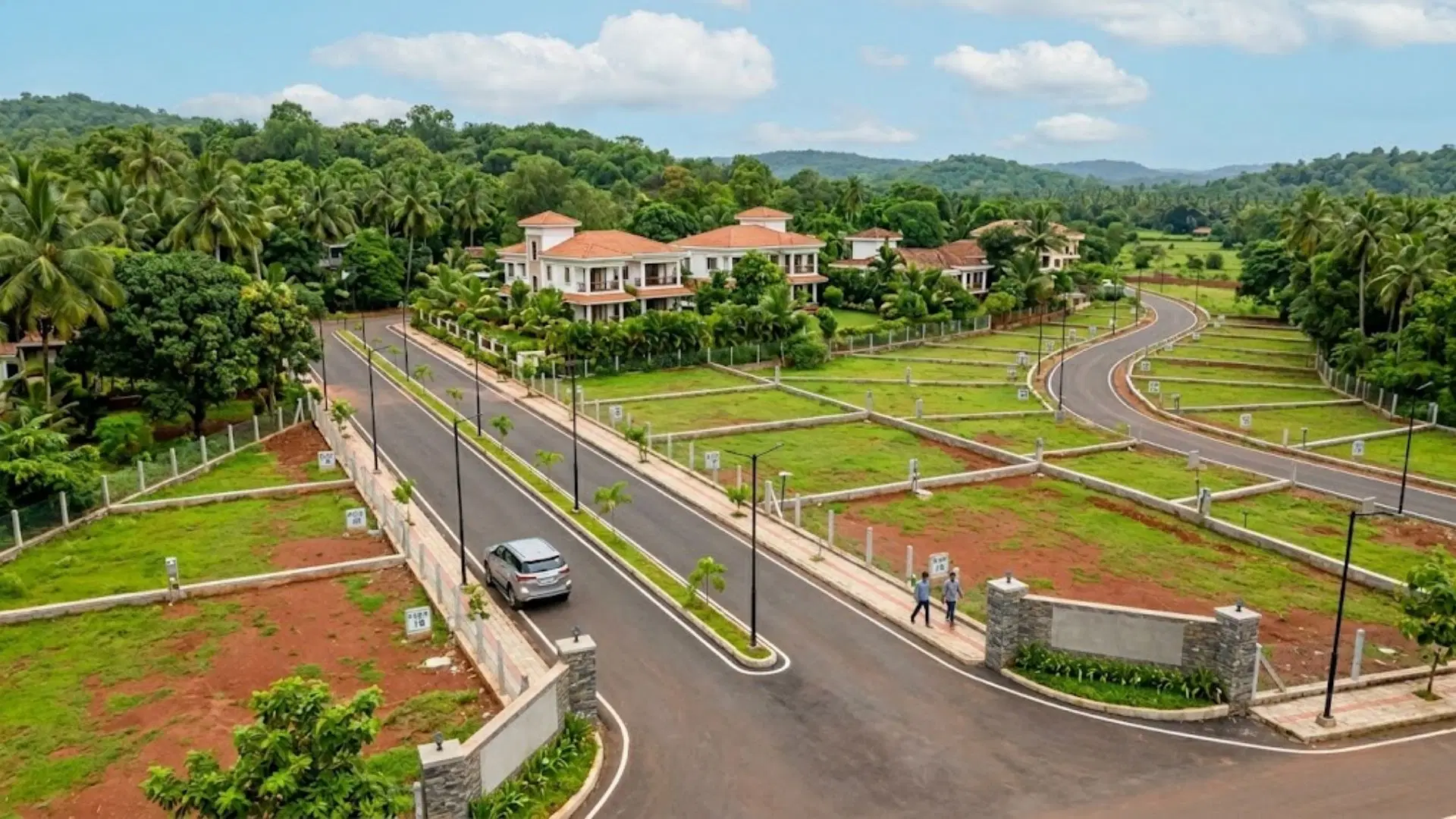 Aerial view of plotted land, internal roads and villas in a green Bicholim setting, highlighting Goa’s potential for land investment.